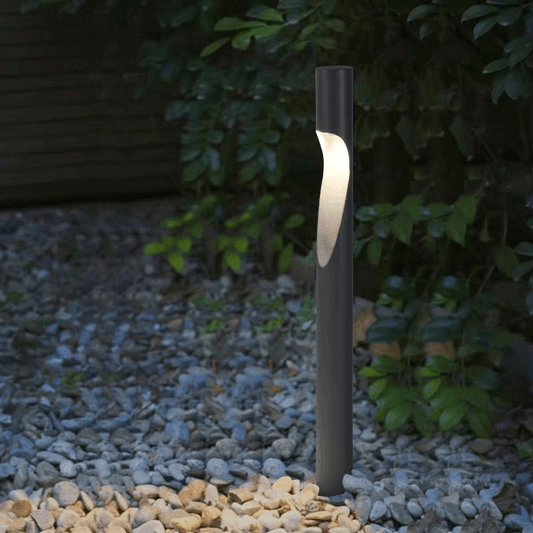 Minimalist waterproof LED garden lamp illuminating pathway stones, enhancing outdoor landscape design.
