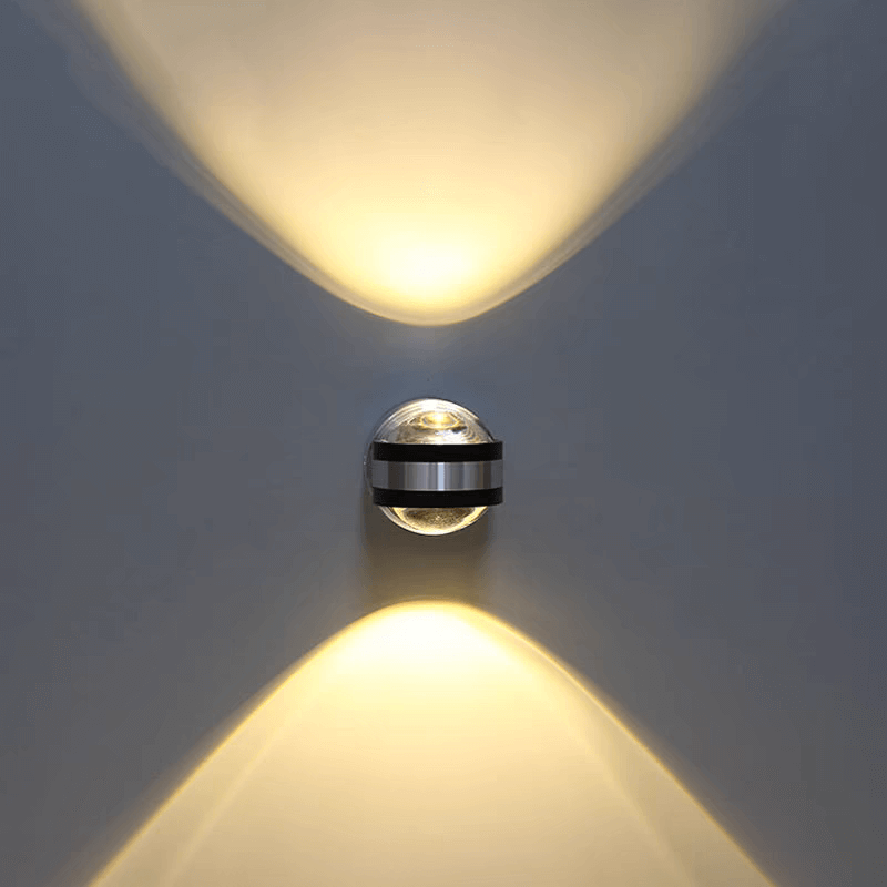 Modern LED wall light with crystal aluminum design casting up/down ambient lighting.