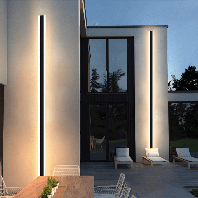 Black LED waterproof outdoor wall light illuminating a modern porch with warm ambiance.