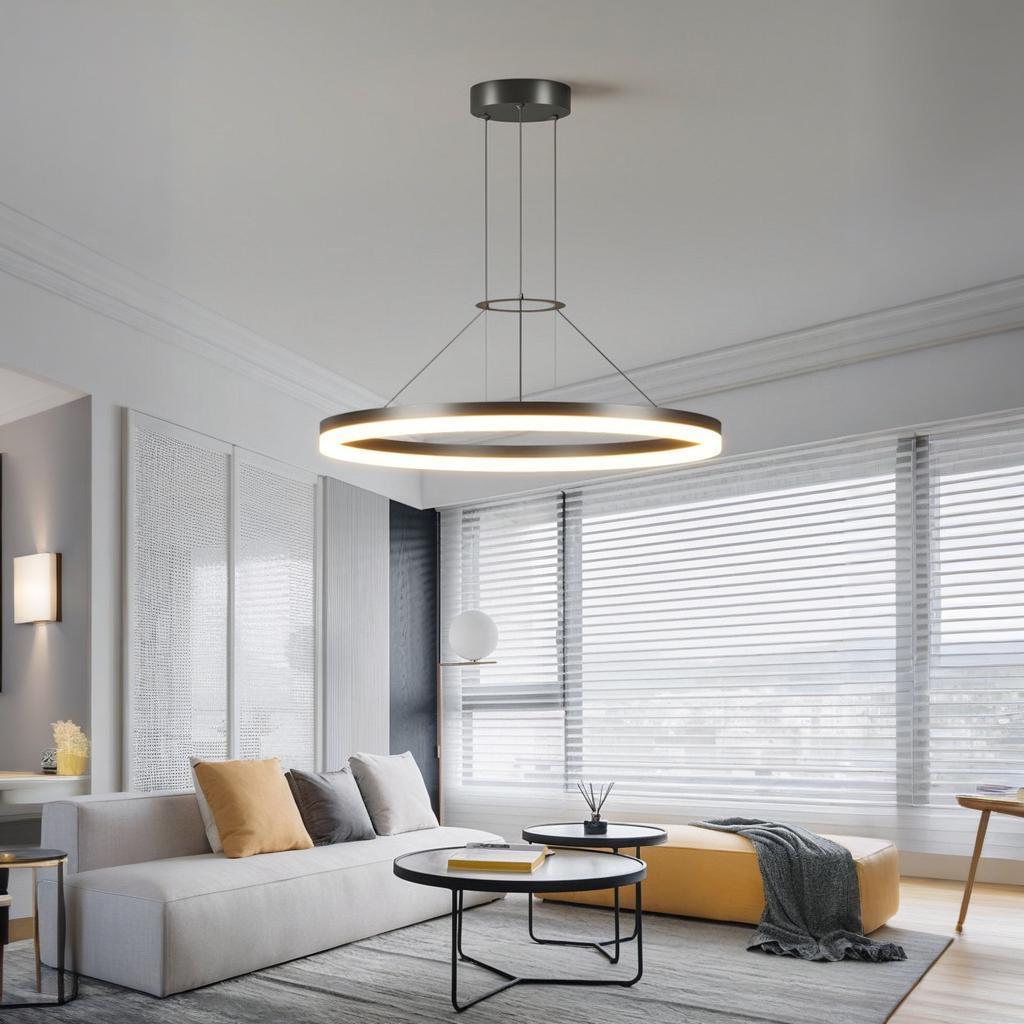 Modern LED Ring Chandelier illuminating a minimalist living room with stylish decor and natural light.