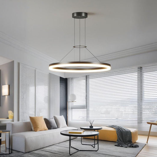 Modern LED Ring Chandelier illuminating a minimalist living room with stylish decor and natural light.