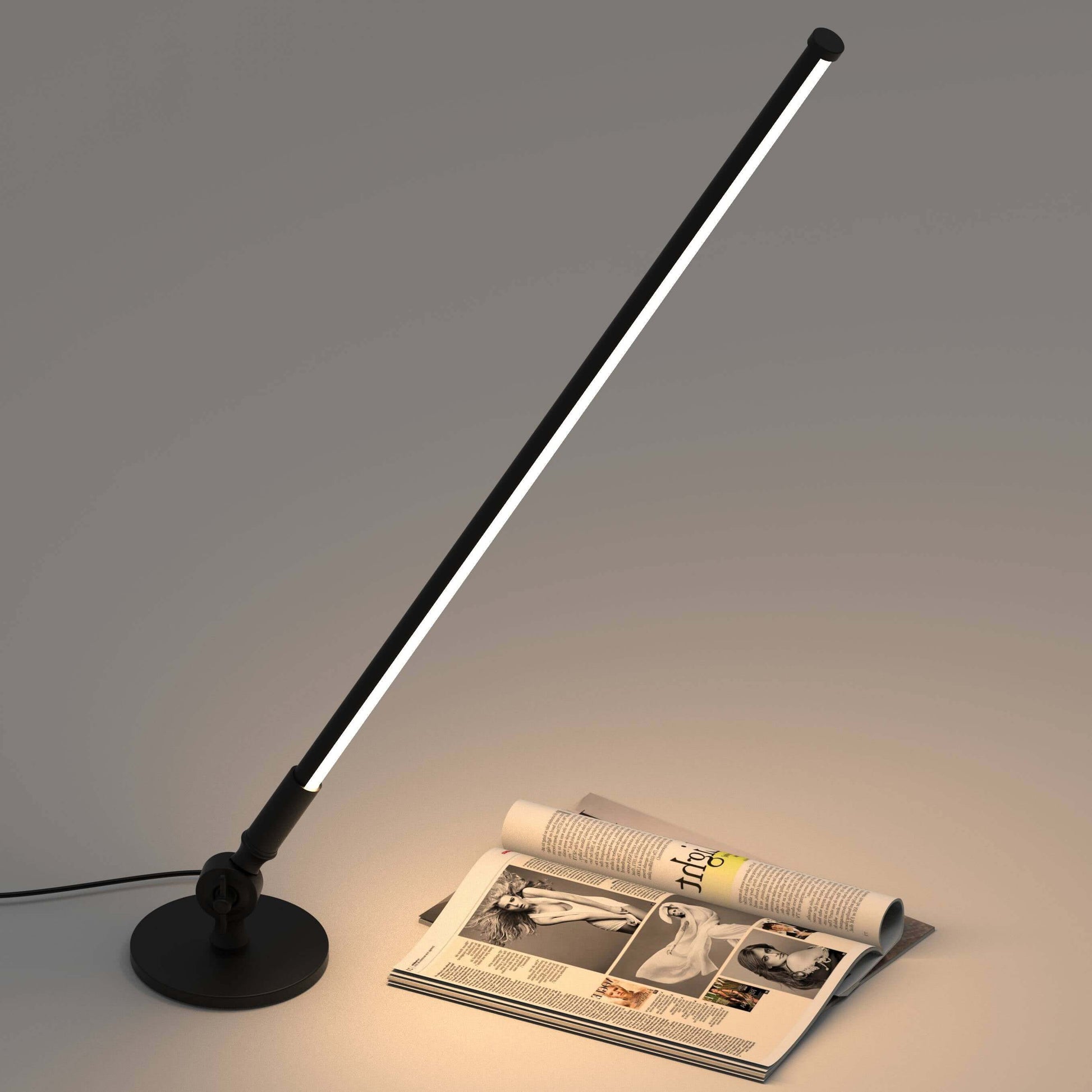 Rotatable LED desk lamp providing soft illumination above a magazine on a table.