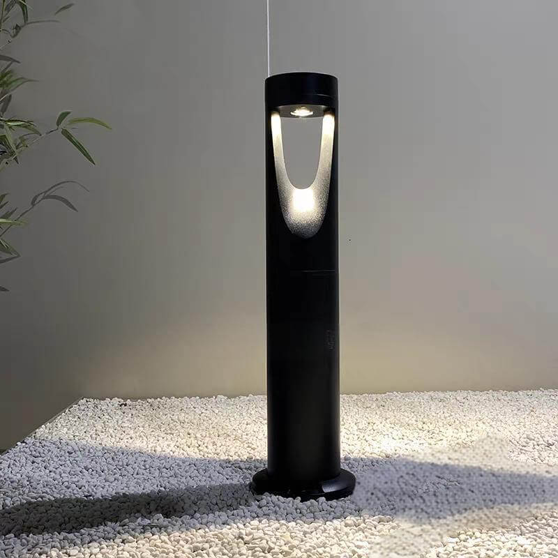 Modern minimalist outdoor waterproof lawn light on gravel, showcasing sleek design and soft LED illumination.